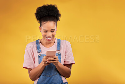 Buy stock photo Mockup, typing and happy woman with phone in studio, texting or social media post with space on yellow background. Networking, chat online and model with cellphone mobile app, reading meme or email