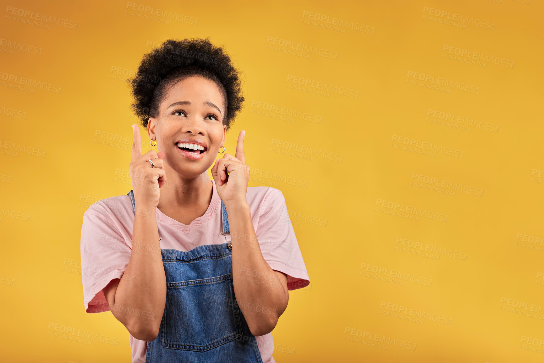 Buy stock photo Smile, pointing and mockup with a black woman on a yellow background in studio for advertising or marketing. Sale, presentation or information with a happy young female brand ambassador showing space