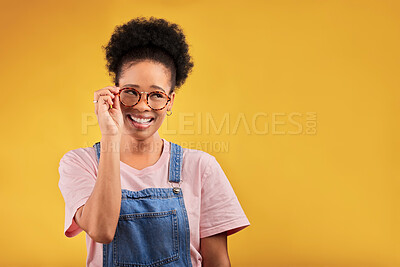 Buy stock photo Smile, glasses and vision with a black woman nerd on a yellow background in studio for style. Fashion, eyewear and a happy young afro female geek at the optometrist for prescription frame lenses