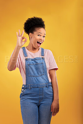 Buy stock photo Portrait, okay and hand gesture with an excited black woman in studio on a yellow background. Smile, wow and perfect with a happy young female person showing a sign of support, feedback or review