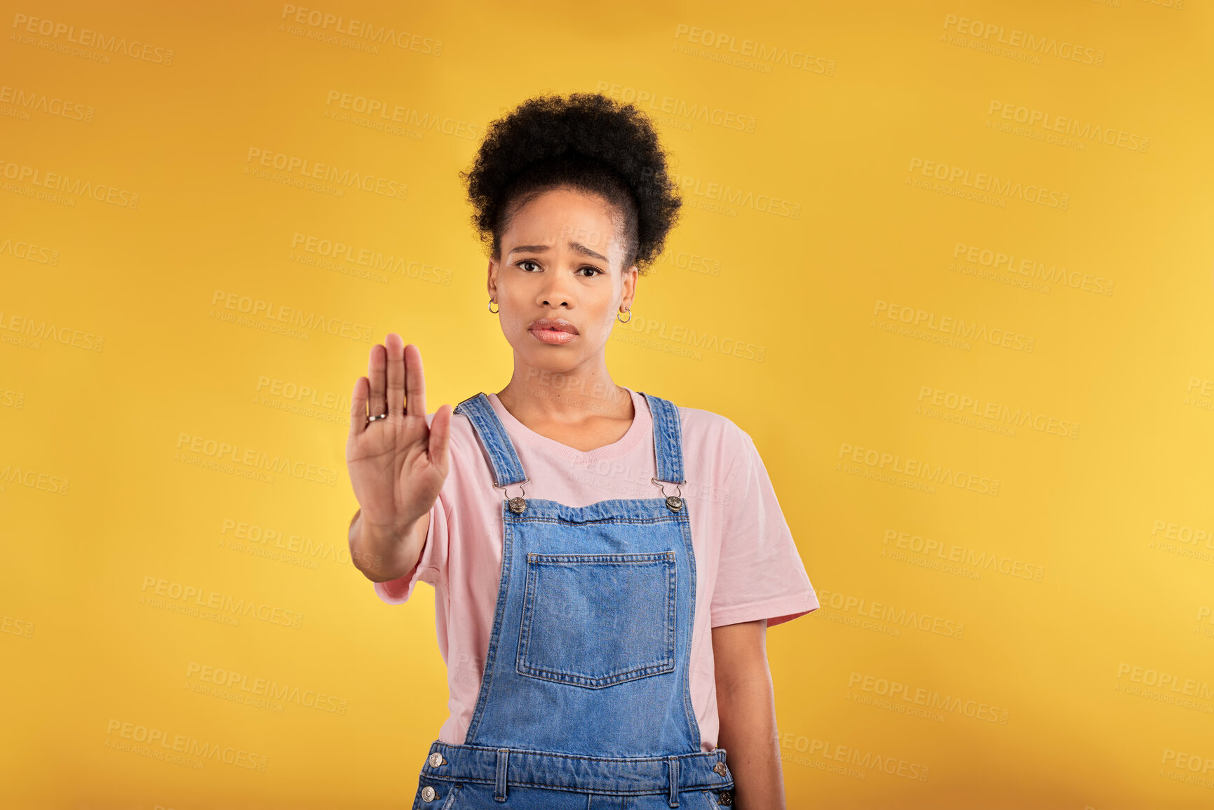Buy stock photo Stop, hand and warning with portrait of black woman in studio for emoji, no and voice. Rejection, opinion and sign with person on yellow background for protest, discrimination and forbidden icon