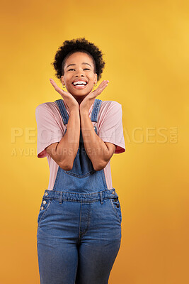 Buy stock photo Wow, celebration and hands on face of black woman in studio happy for news, deal or promo on yellow background. Portrait, smile and African female winner excited for lottery, coming soon or bonus