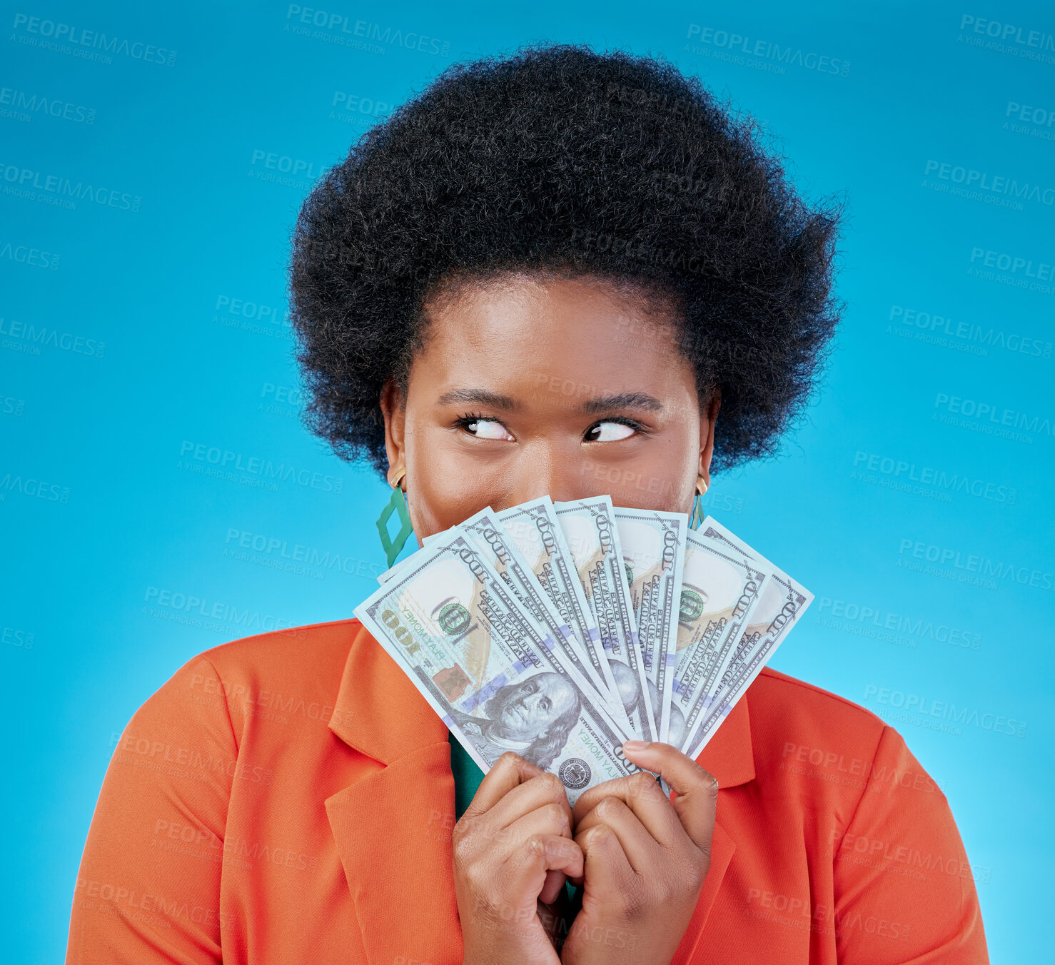 Buy stock photo Cash, hide and a black woman lottery winner on a blue background in studio holding money for finance. Savings, investment or economy growth with a young female person excited for financial freedom