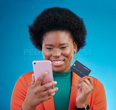 Buy stock photo Black woman, credit card and phone in studio, smile or thinking for choice, ecommerce and blue background. Gen z African girl, smartphone and fintech app for payment, cybersecurity or online shopping