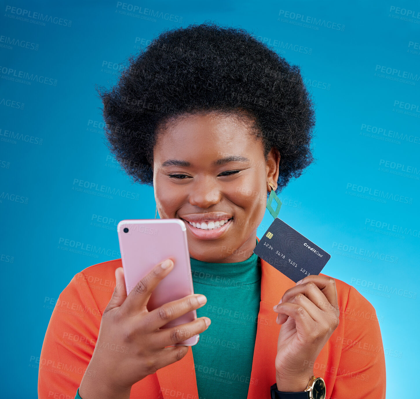 Buy stock photo Black woman, credit card and phone in studio, smile or thinking for choice, ecommerce and blue background. Gen z African girl, smartphone and fintech app for payment, cybersecurity or online shopping