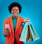 Shopping bag, phone and happy woman for e commerce sale, discount or social media on blue background. Portrait, mobile blog and fashion of african person, customer or online user with gift in studio