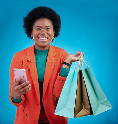 Buy stock photo Shopping bag, phone and happy woman for e commerce sale, discount or social media on blue background. Portrait, mobile blog and fashion of african person, customer or online user with gift in studio
