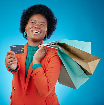 Buy stock photo Woman, credit card and shopping bag for retail banking, finance and e commerce fintech or payment in portrait. Happy customer, fashion model or african person offer or debit on blue studio background