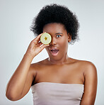 Skincare, apple and portrait of a woman in studio with a natural, organic and beauty face routine. Shock, wellness and African female model with slice of fruit for facial treatment by gray background