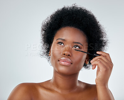 Buy stock photo Black woman, makeup and brush for mascara or beauty with afro against a white background in studio. Face of African person or model applying eye product, cosmetics or lashes for facial treatment