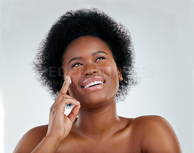 Buy stock photo Face, skincare and black woman with cream in studio isolated on white background. Application, happy and African model with moisturizer, facial cosmetic or sunscreen for dermatology, health or beauty