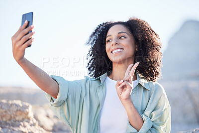 Buy stock photo Woman at beach, selfie and peace hand sign, happy with travel and lifestyle influencer, photography and social media. Post, content creation and female person smile in picture outdoor with adventure