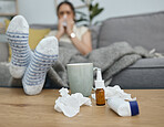 Feet closeup, table and woman on sofa, living room and sick with blowing nose, pain and virus in home. Girl, asthma and medical problem with water, medicine or fatigue on lounge couch in apartment