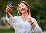 Happy, woman and wave hello to phone for video call, blog or social media, communication or post on internet in the park. Selfie, face and girl with a smile for smartphone conversation or film