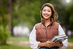 Asian student, portrait and woman with books for learning, education and outdoor on university campus with happiness or pride. Happy, face and girl in college with notebook or walking to class