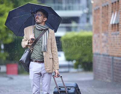 Buy stock photo Thinking, travel and a man with an umbrella and suitcase in the rain in the morning. Serious, winter and a person with luggage for a vacation, immigration or holiday in the city for commute ideas