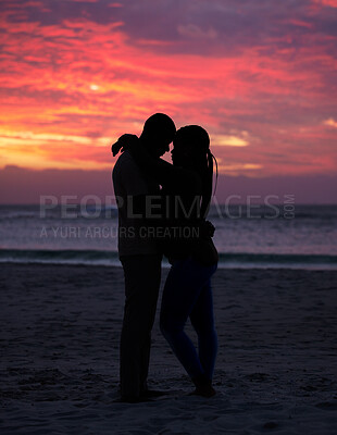 Buy stock photo Couple, sunset and silhouette outdoor at the beach with love, care and commitment. Romantic man and woman hug or affectionate on vacation, holiday or nature travel adventure with sunrise sky on date