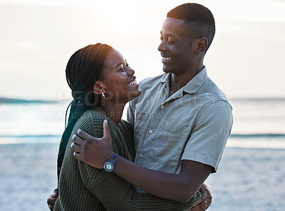 Buy stock photo Black couple, hug and happy outdoor at the beach with love, care and commitment. Smile on face of young african man and woman together on vacation, holiday or sunset travel adventure in Jamaica