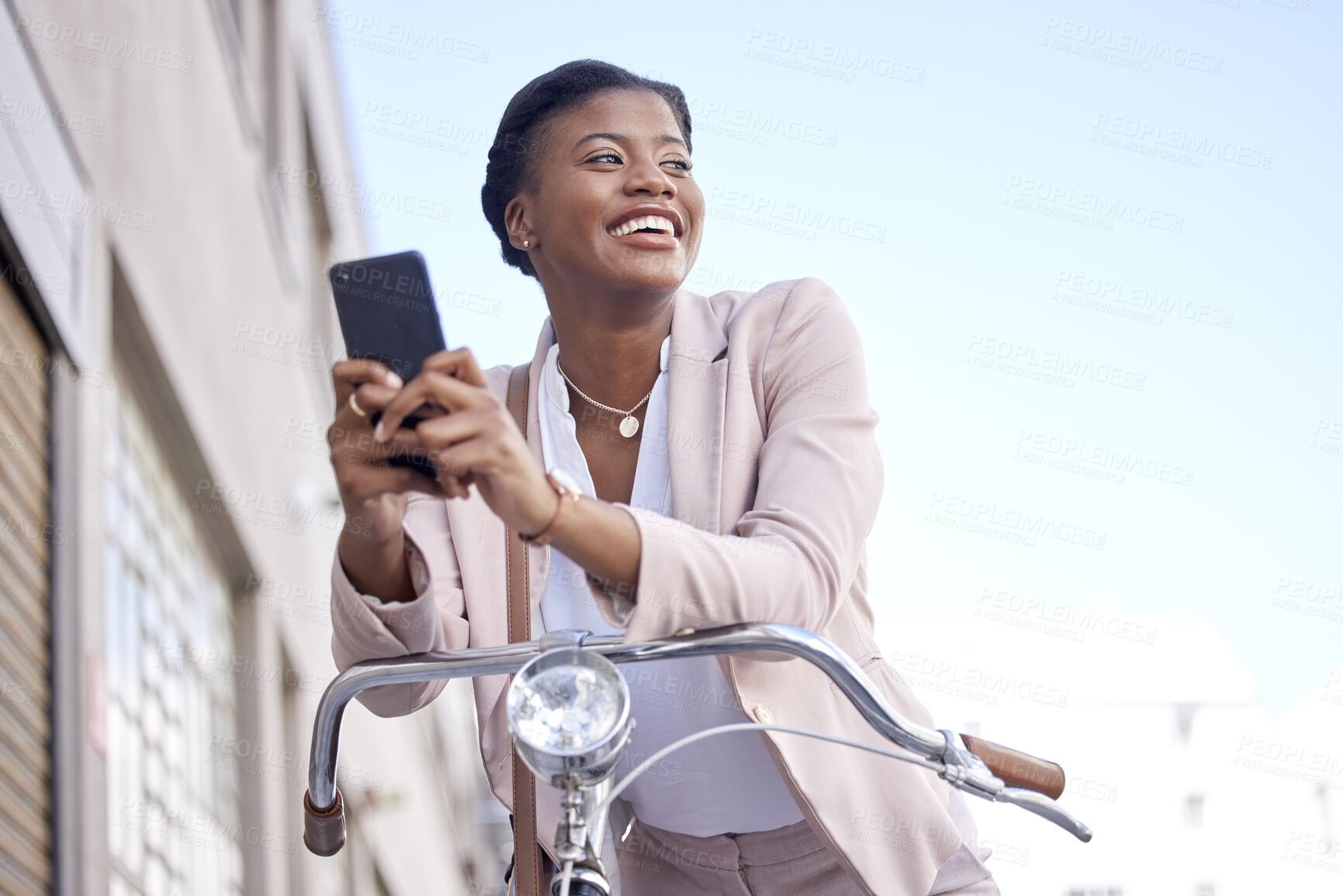 Buy stock photo Happy business woman in city with bike, phone and morning commute, checking location or social media. Eco friendly transport bicycle, cycling and African girl with mobile app, smile and work travel.