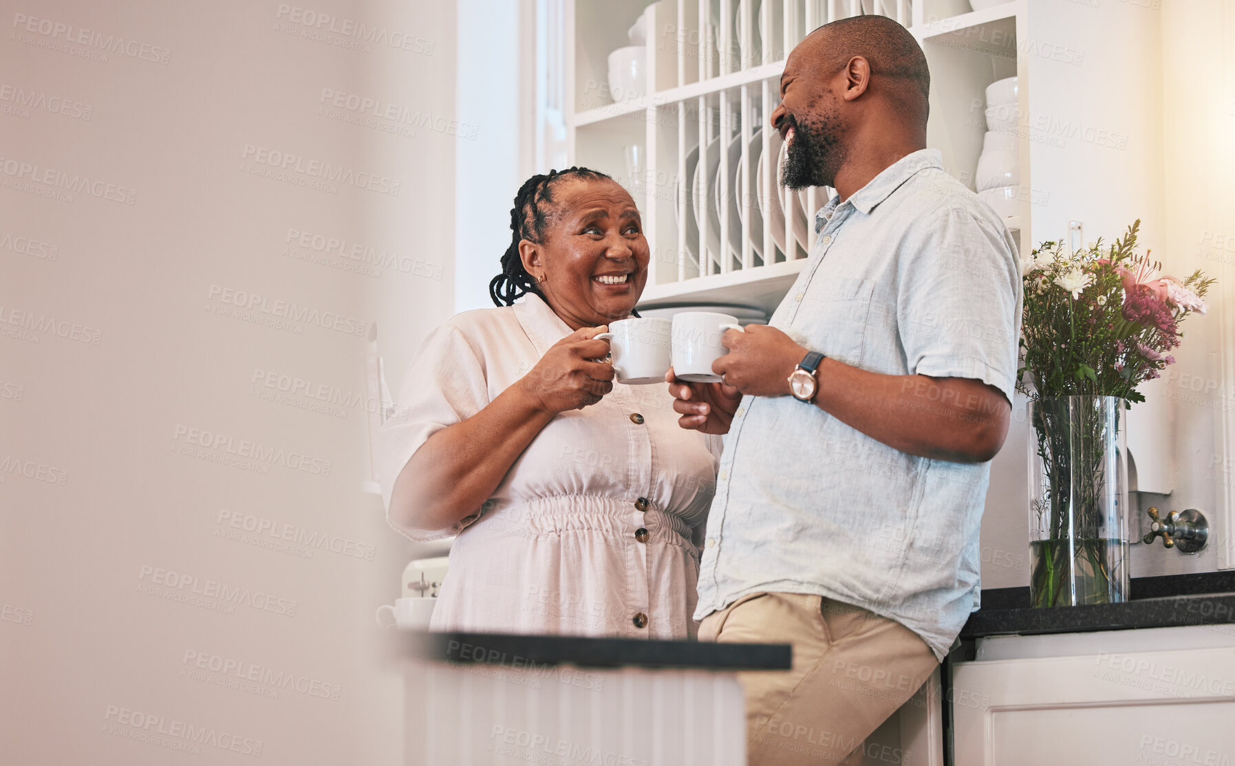 Buy stock photo Coffee, happy and a talking black couple in the kitchen, laughing and relax in the morning. Smile, love and an elderly African man and woman speaking with a tea drink and conversation in a house