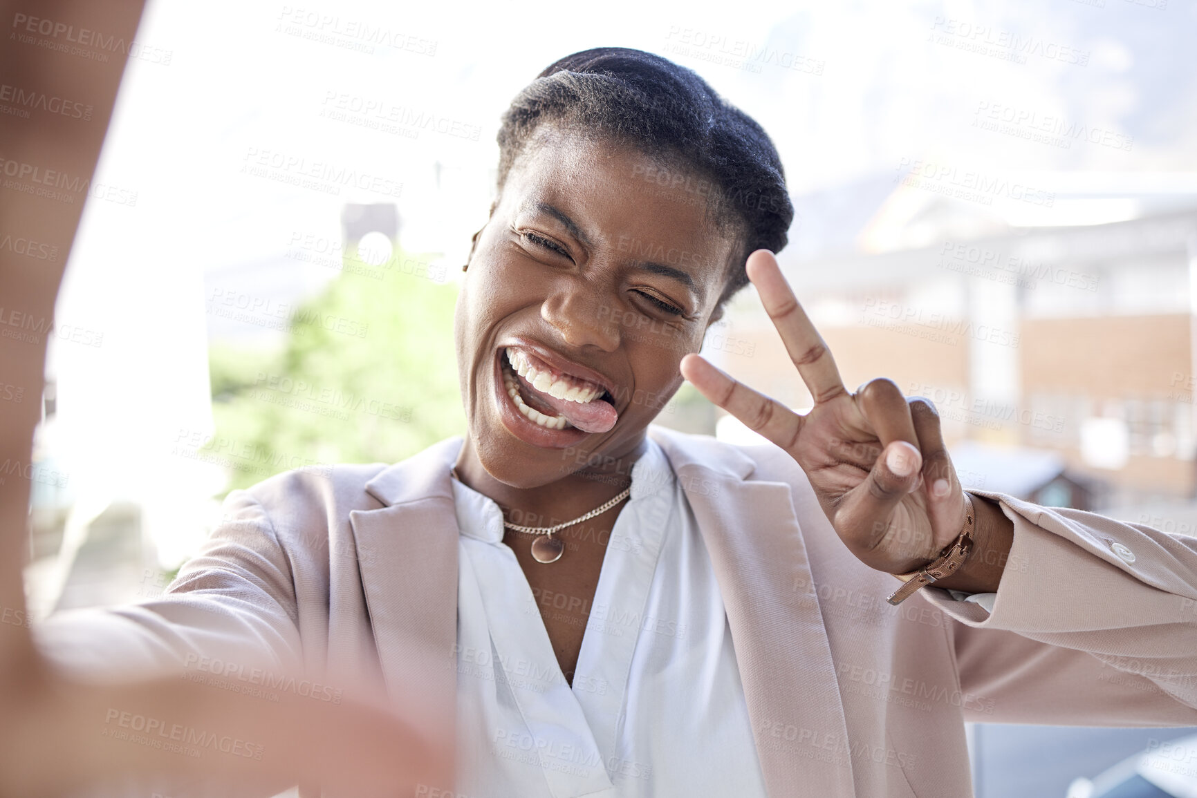 Buy stock photo Happy black woman, peace sign and selfie in city with tongue out for photograph, memory or vlog outdoors. Face of female person or employee smile for fun picture, humor or happiness in an urban town