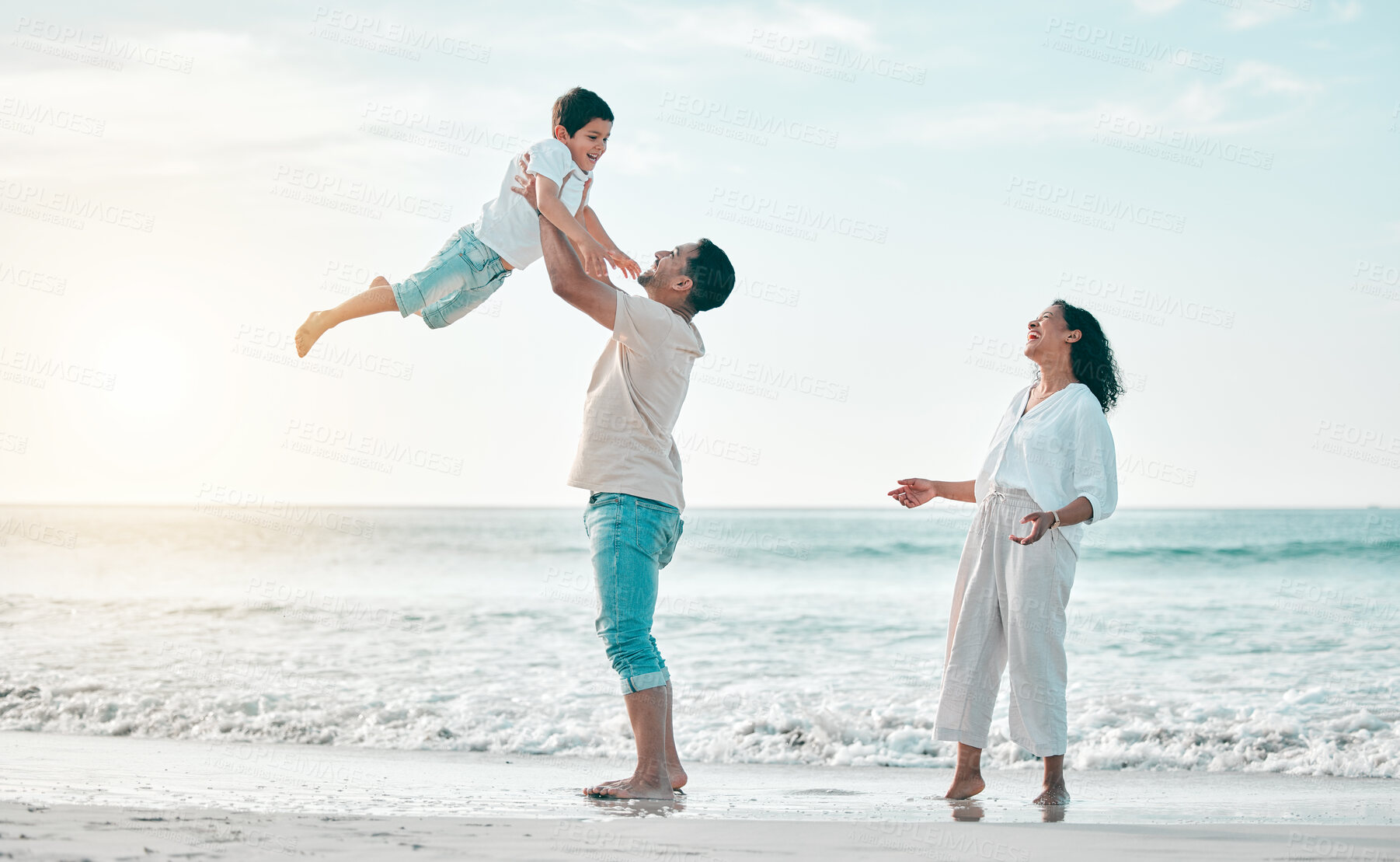 Buy stock photo Family, beach and father lifting boy child with love, freedom and travel celebration in nature. Flying, fun and parents with kid at the ocean for bond, happy and airplane game while traveling in Bali