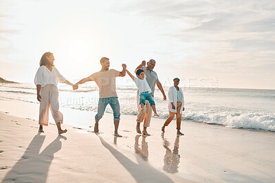 Buy stock photo Holding hands, big family and swing at the beach walking with freedom, travel and bonding at sunset. Love, lifting and and boy child with grandparents and parents at sea on walk for summer holiday