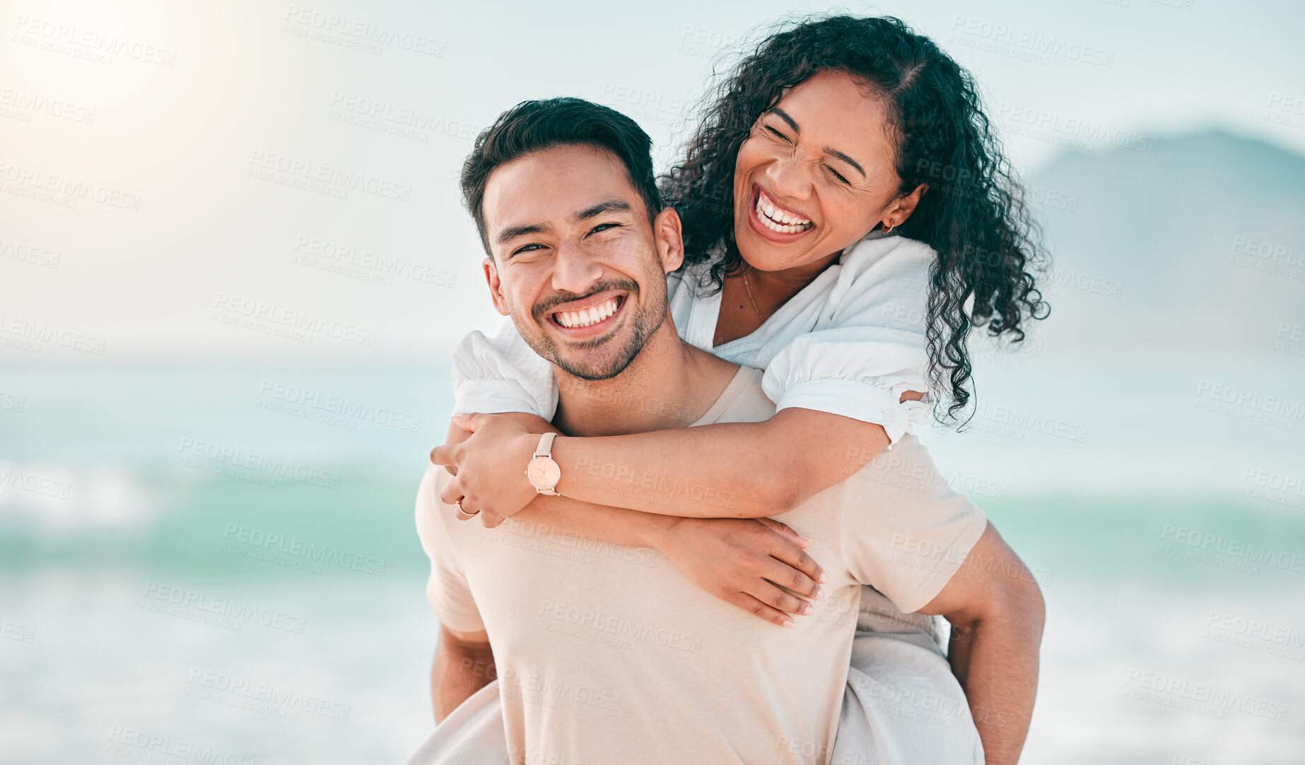 Buy stock photo Love, happy and piggyback with couple on beach for travel, summer and vacation. Peace, smile and relax with portrait of man and woman hugging on date for seaside holiday, care and mockup space