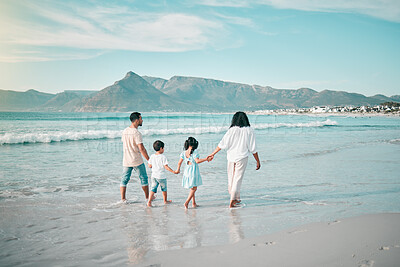 Buy stock photo Family walk on a beach, holding hands and bonding in nature, back view with ocean waves and summer in Mexico. Parents, kids and people outdoor on holiday, freedom and travel with trust and love