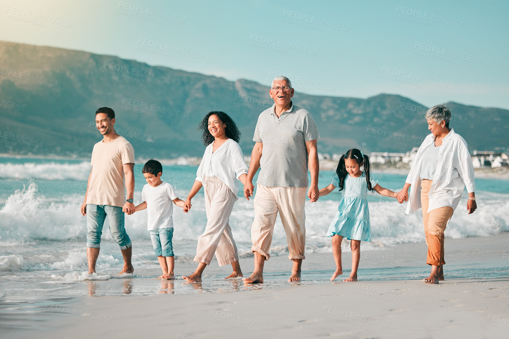 Buy stock photo Holding hands, family is walking on beach and ocean, generations and bonding in nature with waves. Grandparents, parents and kids, people outdoor and travel with trust and love on Mexican holiday