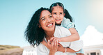 Hug, piggyback and mom with her girl child playing outdoor in the garden at their family home. Happy, smile and young mother carrying her kid on her back bonding and playing together in the backyard.