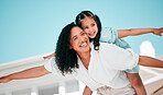 Smile, airplane and mother with her child in the outdoor garden at their family home for adventure. Playful, happy and young mom carrying her girl kid on her back while bonding and playing together.