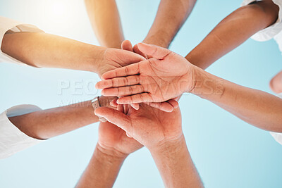 Buy stock photo Circle, low angle and team with hands together for collaboration, unity or support by a blue sky. Teamwork, diversity and group of people in an outdoor huddle for motivation, solidarity or community.