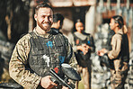 Paintball game, portrait and happy man in battlefield, challenge or military mission, gun fight or conflict. Happiness, soldier smile and male player ready for war training, action or battle training