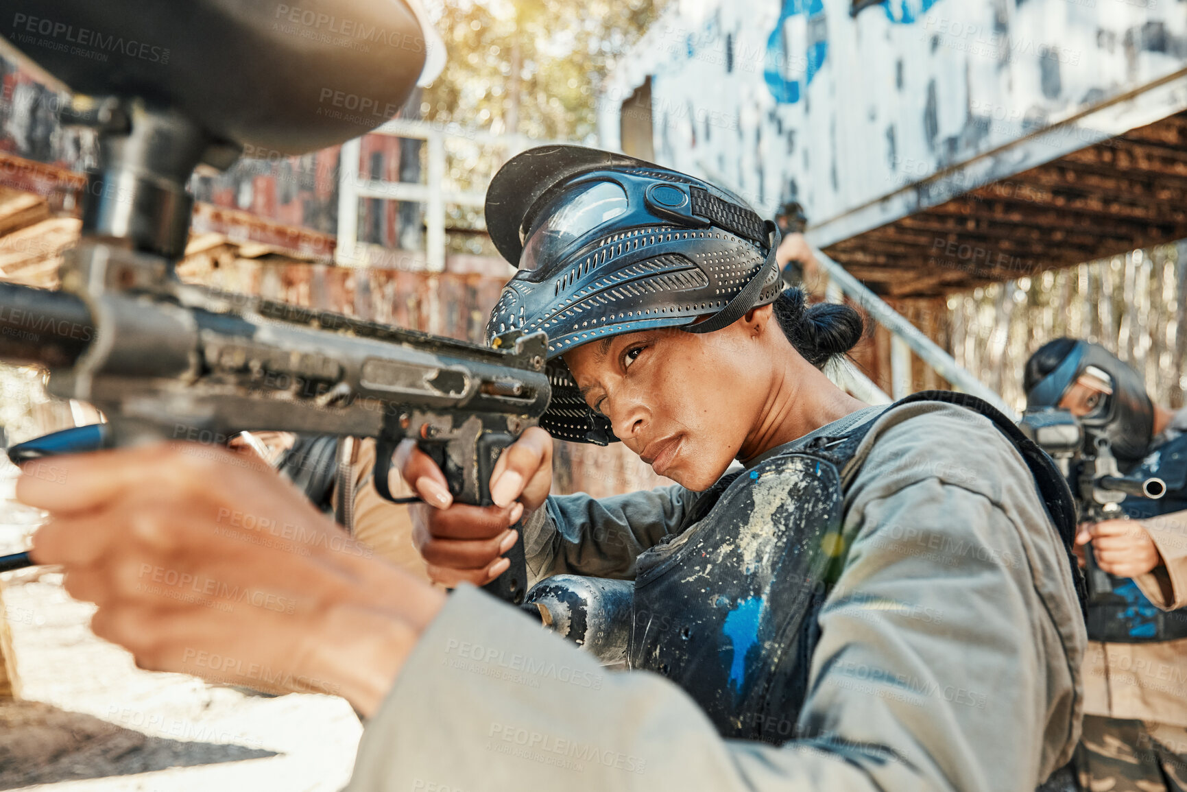 Buy stock photo Paintball gun, focus and woman aim, shooting and target soldier, action warrior or training for battlefield fight conflict. Army mission gear, military practice arena and female shooter in war battle
