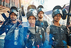 Paintball, focus and portrait of team or people ready for a battle and teamwork or collaboration together. Serious, sports and army on a mission on the battlefield with guns for  outdoor competition