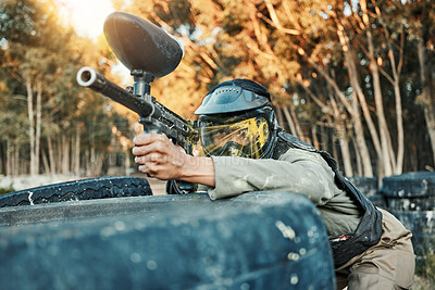 Buy stock photo Paintball, sports and person in action with gun for tournament, competition and battle in nature. Camouflage, military and woman shooting in outdoor arena for training, adventure games and challenge