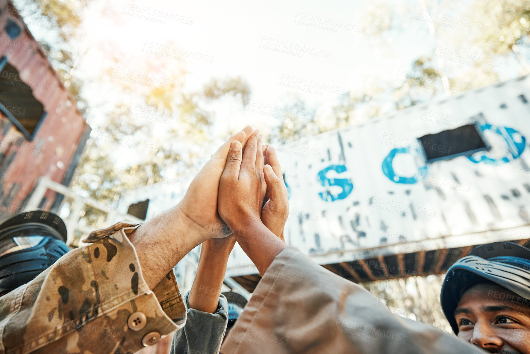 Buy stock photo Paintball, hands and high five for teamwork, support or trust in game plan, collaboration or unity on battle field. Group of paintballers touching hand for team building motivation before match start