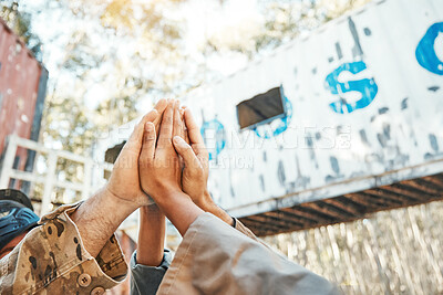 Buy stock photo Paintball, hands and high five for support, motivation or teamwork in game plan, collaboration or unity on battlefield. Group of people touching hand in goal, team or trust together for match start