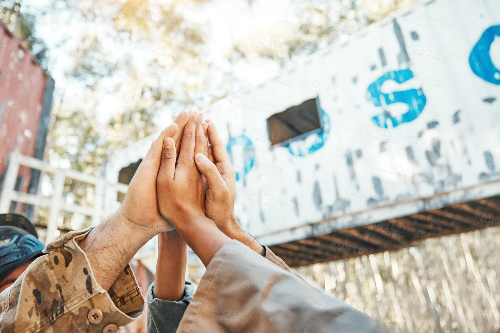 Buy stock photo Paintball, hands and high five for support, motivation or teamwork in game plan, collaboration or unity on battlefield. Group of people touching hand in goal, team or trust together for match start