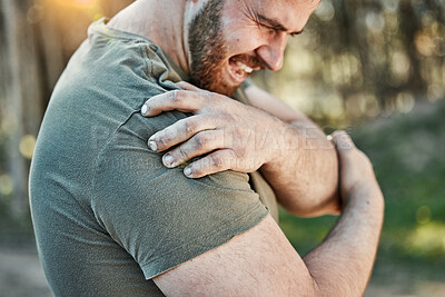 Buy stock photo Man, outdoor and shoulder pain with fitness, injury and tension with sports, workout and accident. Male person, guy and athlete with injured arm, park and strain with inflammation with emergency