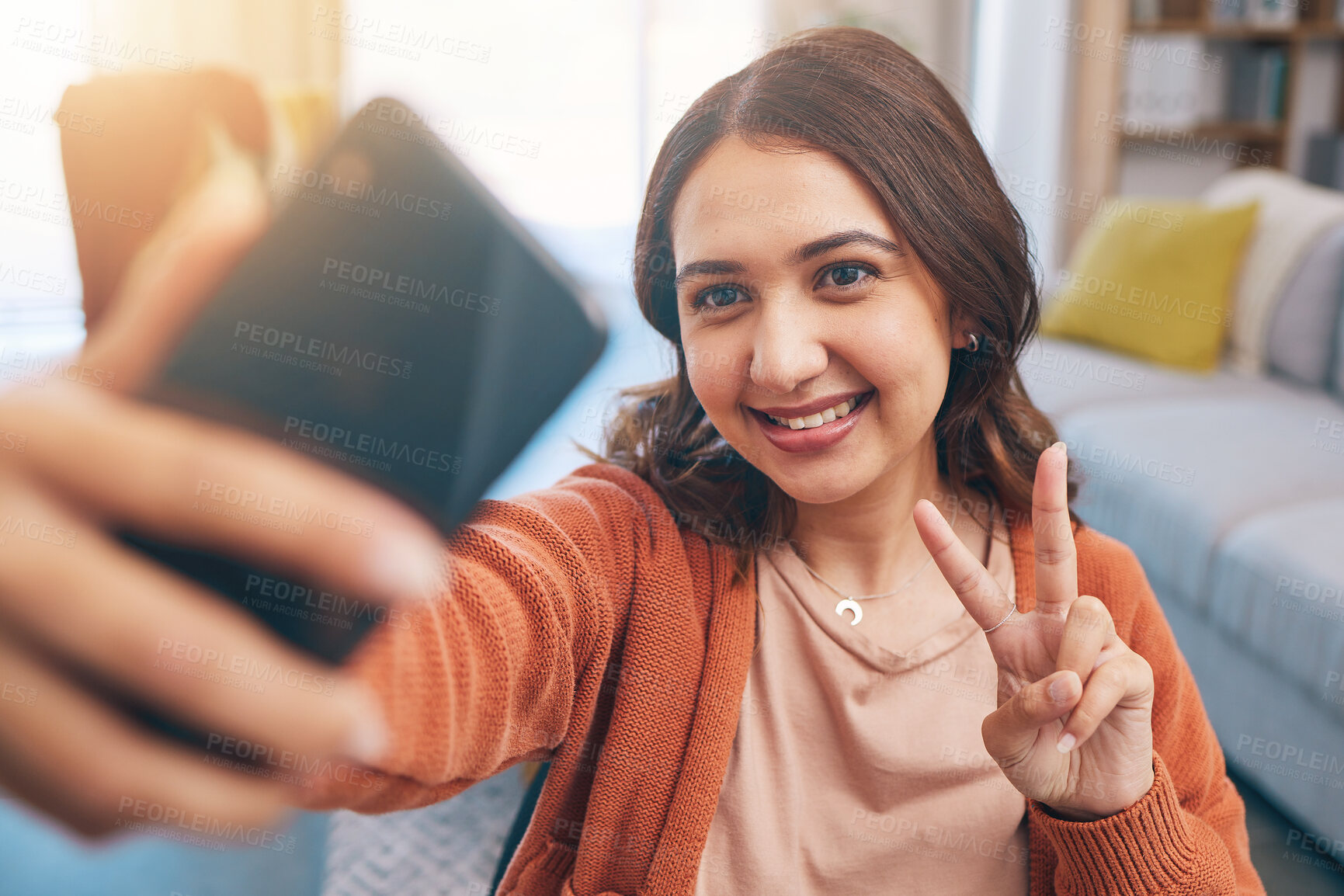 Buy stock photo Face, woman and peace for selfie with smile in home while live streaming on video call in living room. Profile picture, happy female gen z and show v sign, hand emoji and memory for social media post