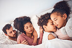 Comfort, sleeping and family in a bed with love, dreaming and resting in their home together. Sleep, nap and children with parents in a bedroom embracing, peaceful and hugging, comfortable and bond