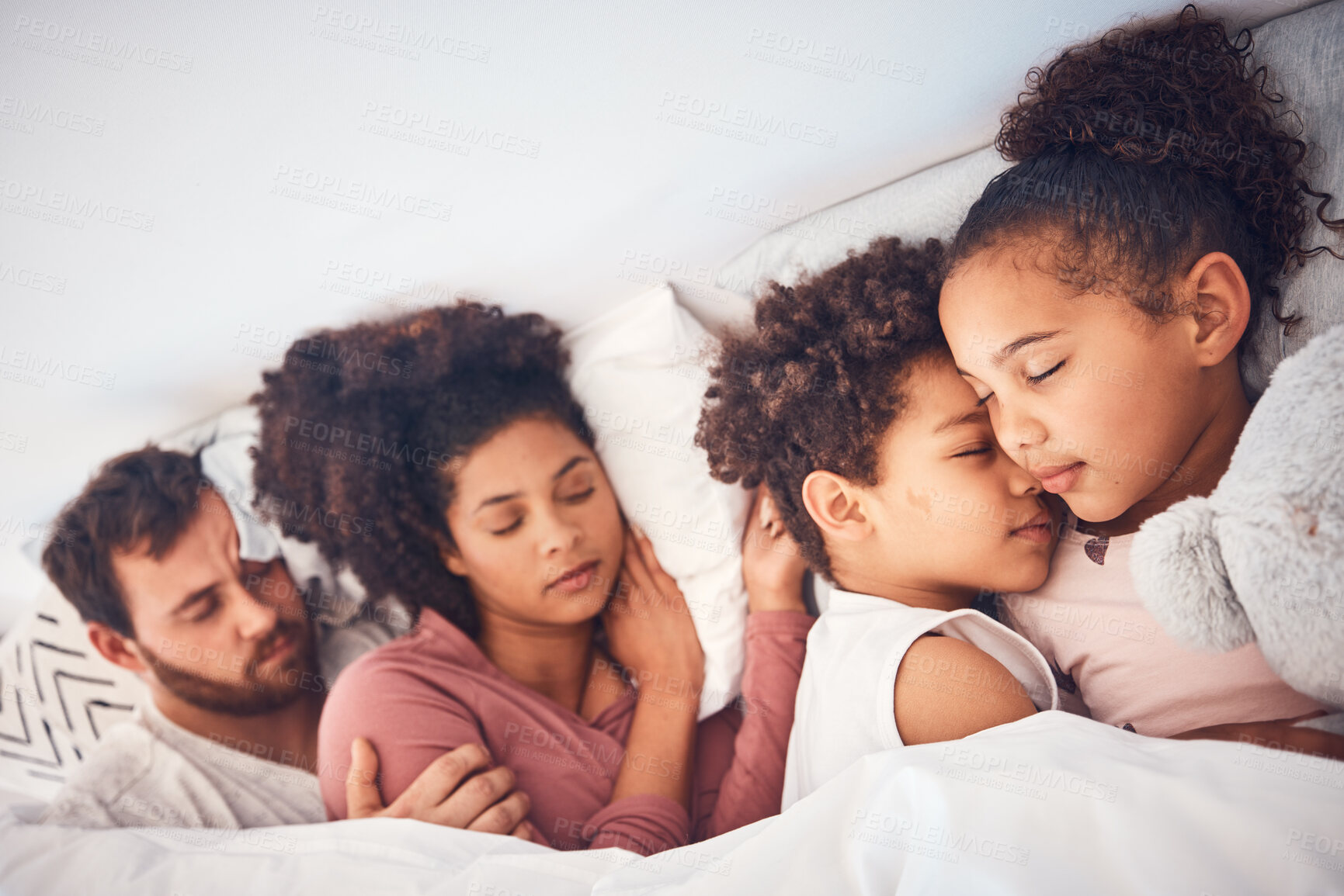Buy stock photo Comfort, sleeping and family in a bed with love, dreaming and resting in their home together. Sleep, nap and children with parents in a bedroom embracing, peaceful and hugging, comfortable and bond