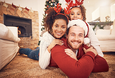 Buy stock photo Christmas, happy family and portrait in home on floor, bonding and together. Xmas, smile and face of parents with girl, interracial and African mom with father for party, celebration and holiday