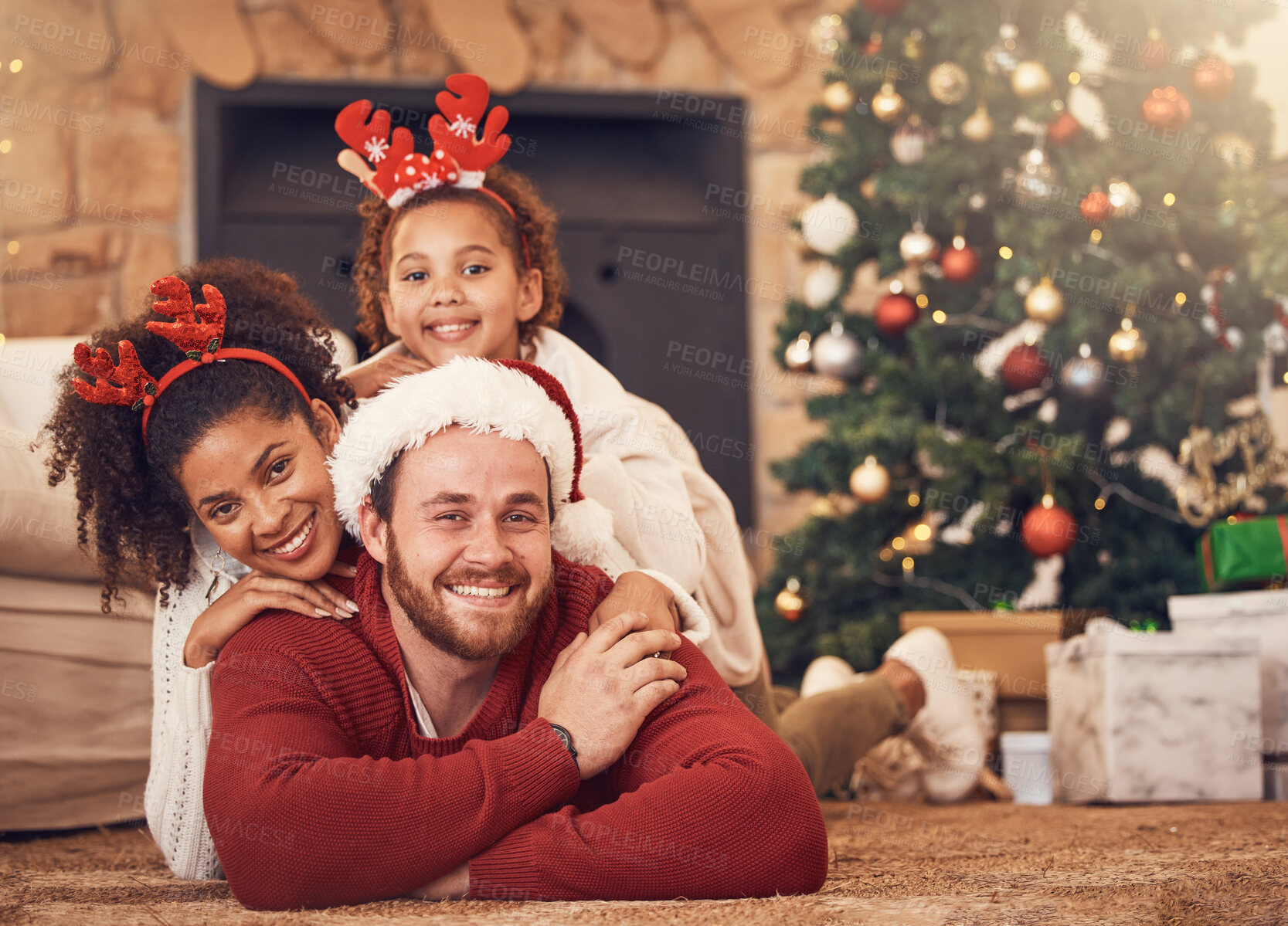 Buy stock photo Christmas, portrait and happy family in house on floor, bonding and together. Xmas, smile and face of parents with child, interracial and African mother with father for party, celebration and holiday