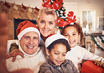 Christmas, portrait and selfie of grandparents with children in home, bond and happy together. Xmas, face and grandma and grandpa with kids, interracial and profile picture for celebration of holiday