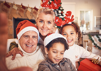 Buy stock photo Christmas, portrait and selfie of grandparents with children in home, bond and happy together. Xmas, face and grandma and grandpa with kids, interracial and profile picture for celebration of holiday