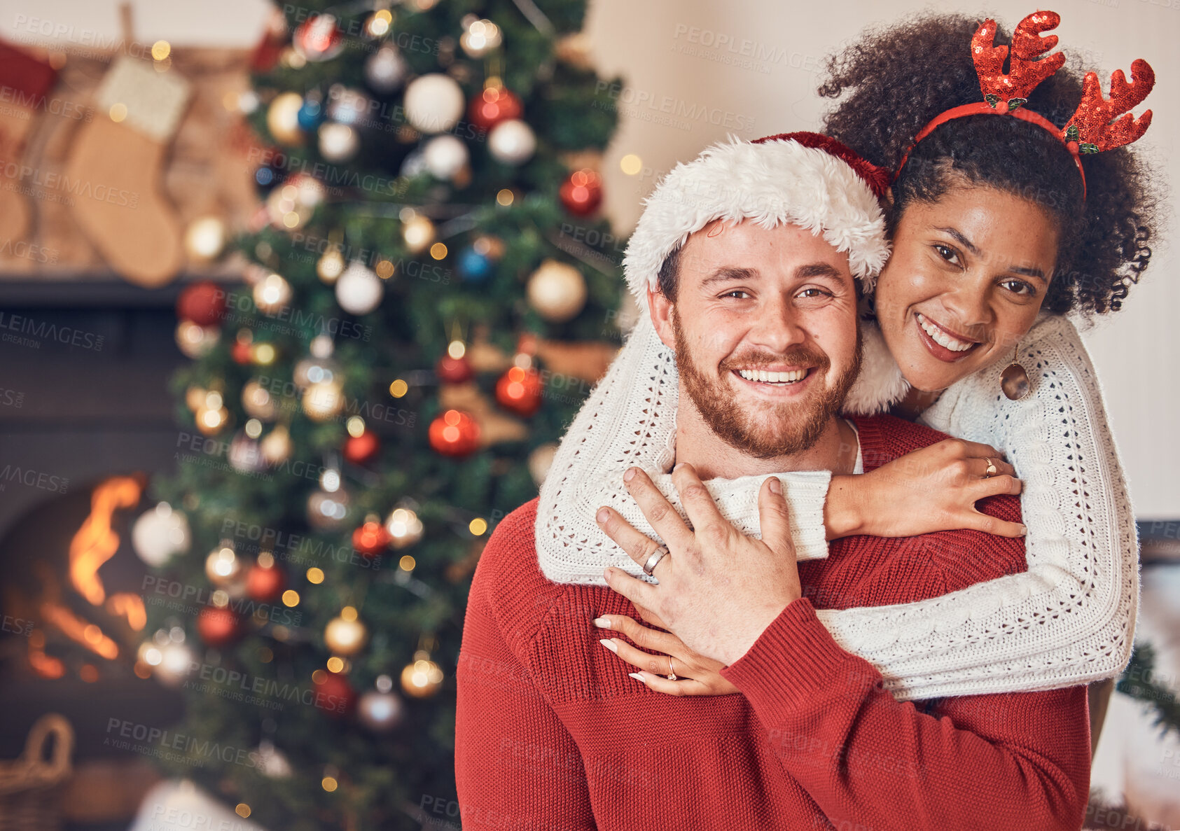 Buy stock photo Christmas, portrait and happy couple in home, hug and bonding together. Xmas, smile and face of man with African woman, interracial and enjoying quality time for party, celebration and winter holiday