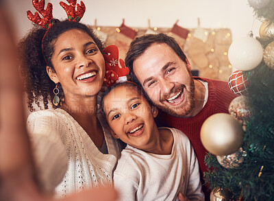 Buy stock photo Christmas, happy family and portrait, selfie and funny together in home. Xmas, smile and face of parents with girl, interracial and African mom laughing with father for party, celebration and holiday